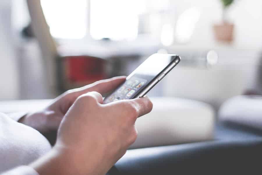 woman-using-her-iphone-at-home-office