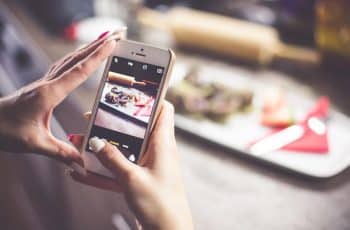 girl taking a photo of her food with iphone picjumbo com 1