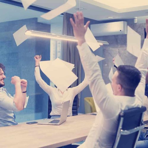 startup group of young business people throwing PQMZSAP 1